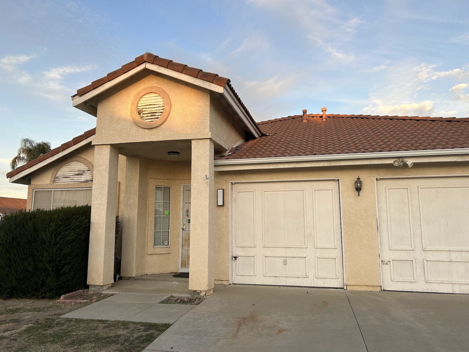 Older single-story family home with a quiet front yard